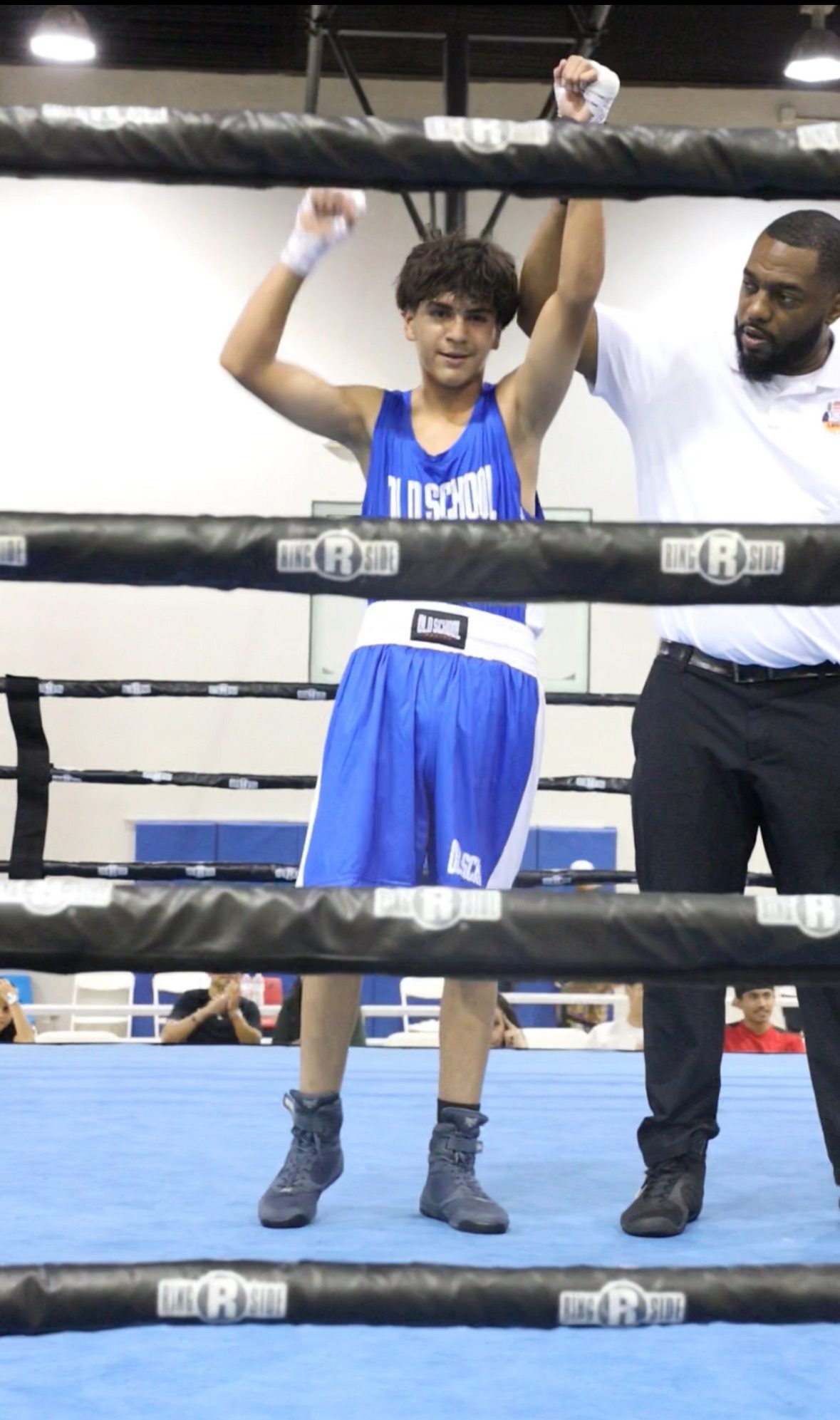 Old School Boxing Club amateur fighter with hand raised in victory