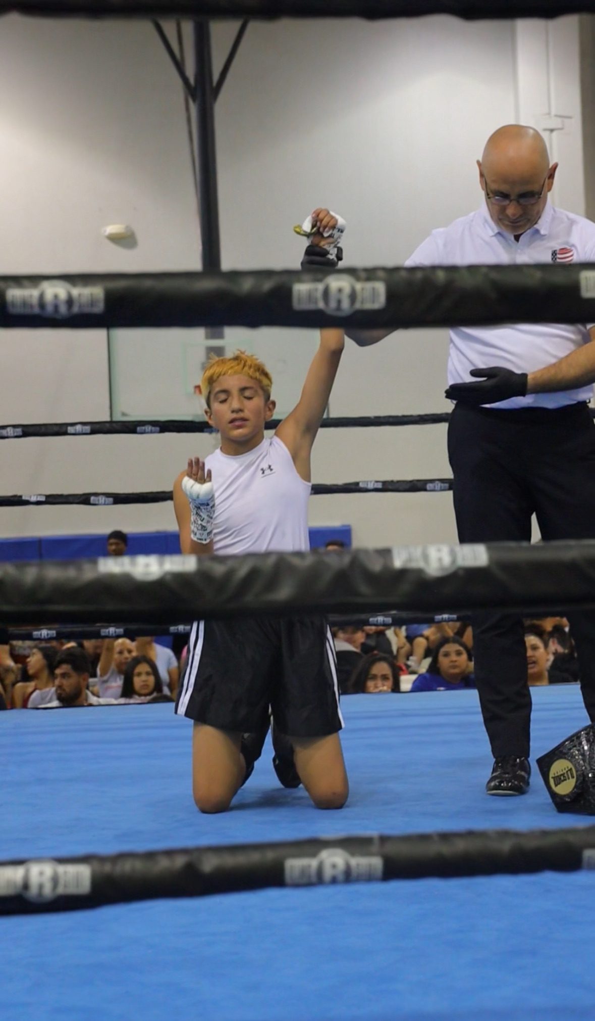 USA Boxing official raising the hand of an Old School Boxing Club amateur fighter