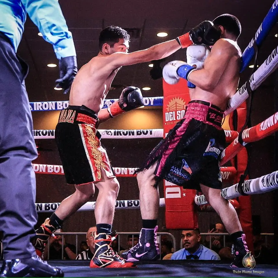 Miguel Ceballos driving his opponent toward the ropes