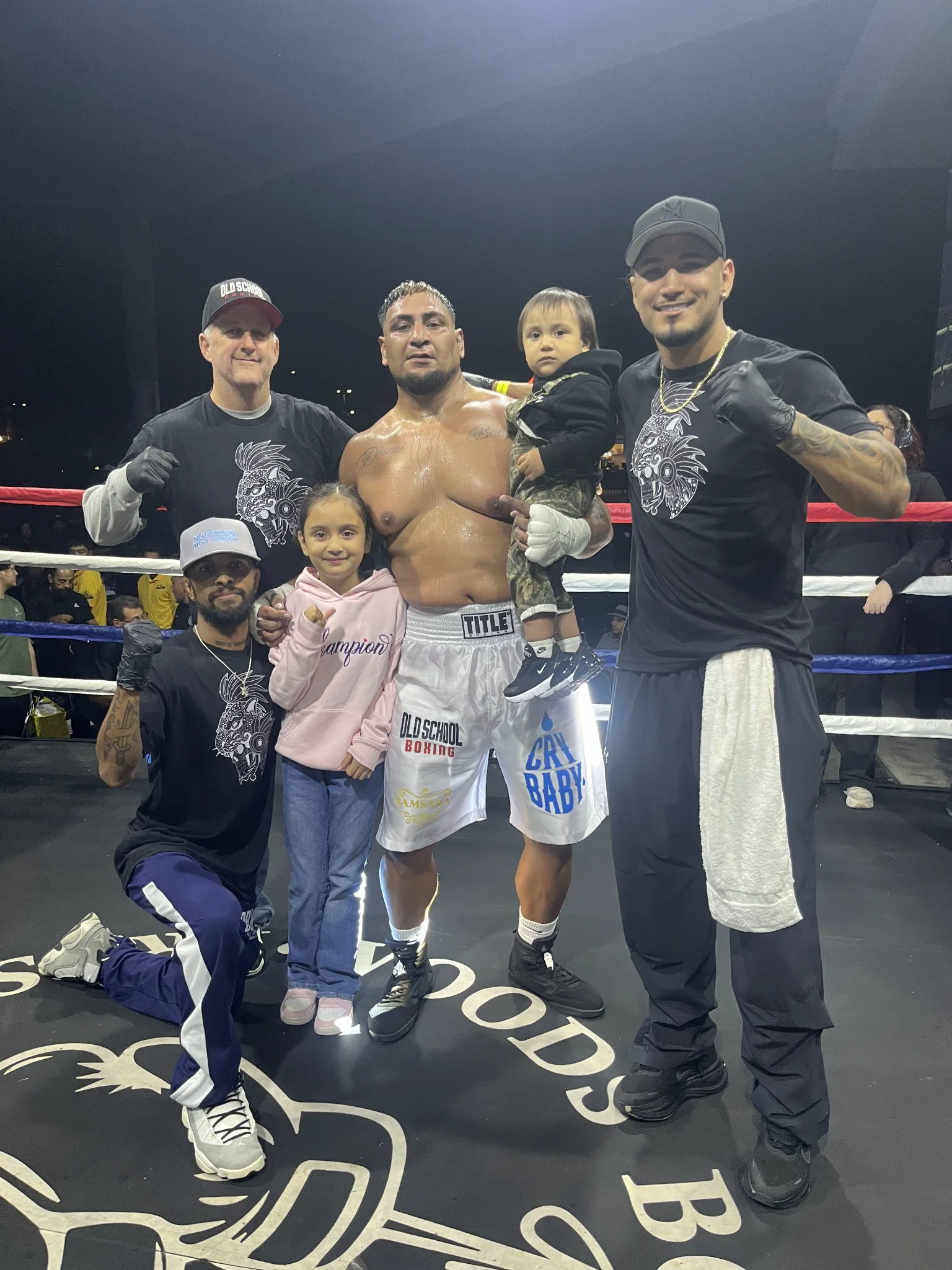 Steven Gurrola celebrates his professional boxing debut victory with his team and family